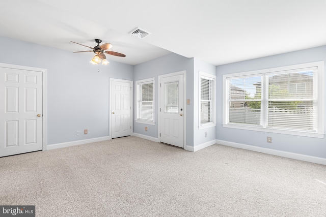 unfurnished bedroom featuring light carpet, baseboards, and ceiling fan