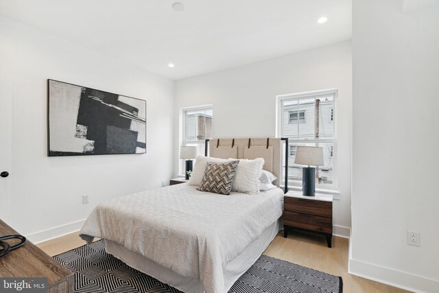 bedroom featuring light wood-type flooring, recessed lighting, and baseboards