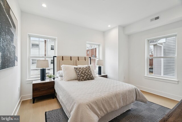 bedroom featuring recessed lighting, baseboards, visible vents, and light wood finished floors