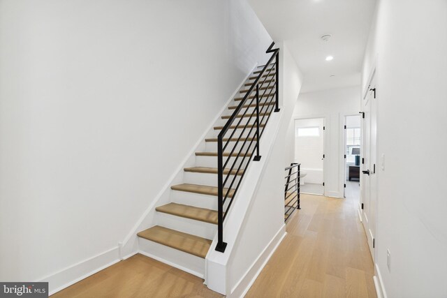 stairs featuring recessed lighting, baseboards, and wood finished floors