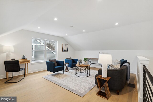 living area featuring recessed lighting, baseboards, vaulted ceiling, and light wood-type flooring