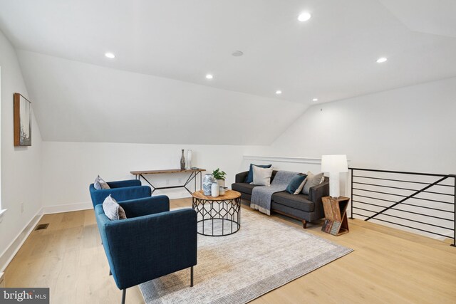 living area with visible vents, wood finished floors, baseboards, lofted ceiling, and recessed lighting