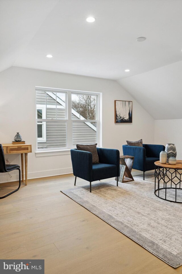 living room featuring wood finished floors, recessed lighting, and lofted ceiling