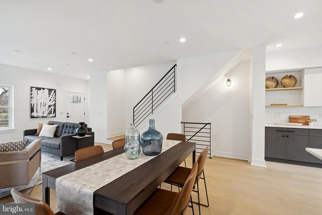 dining room featuring recessed lighting, baseboards, and light wood finished floors