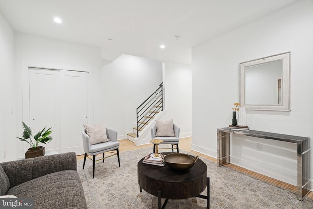 living area featuring stairs, recessed lighting, baseboards, and wood finished floors