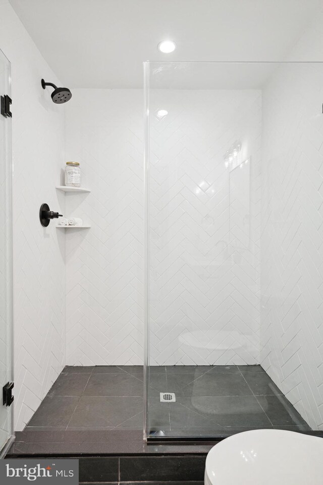 full bathroom featuring recessed lighting, a shower stall, and toilet