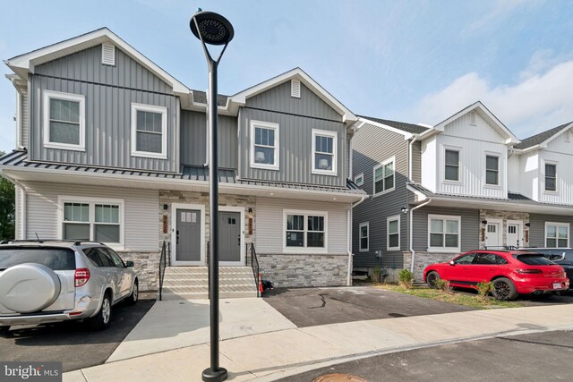 view of property featuring board and batten siding and stone siding