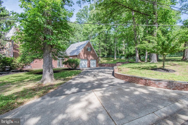 6911 Wells Pkwy, University Park, MD 20782 - view of front of property featuring a garage, an outbuilding, and a front yard