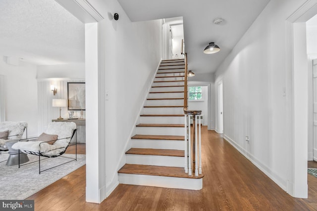 6911 Wells Pkwy, University Park, MD 20782 - stairway featuring wood finished floors and baseboards
