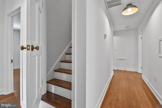 6911 Wells Pkwy, University Park, MD 20782 - hallway with wood finished floors, baseboards, and stairway