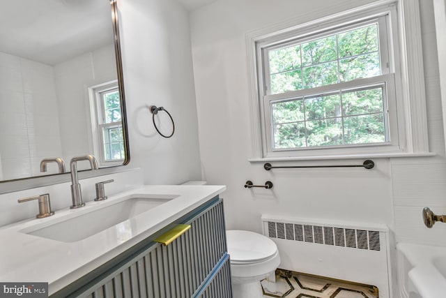 6911 Wells Pkwy, University Park, MD 20782 - full bath featuring radiator, toilet, a bath, and vanity
