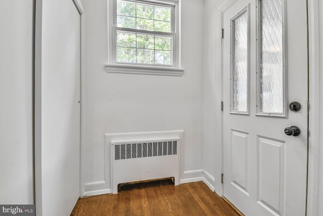6911 Wells Pkwy, University Park, MD 20782 - entrance foyer featuring radiator heating unit, dark wood finished floors, and baseboards