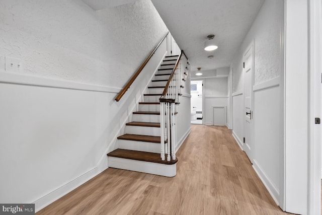 6911 Wells Pkwy, University Park, MD 20782 - stairs with wood finished floors and baseboards
