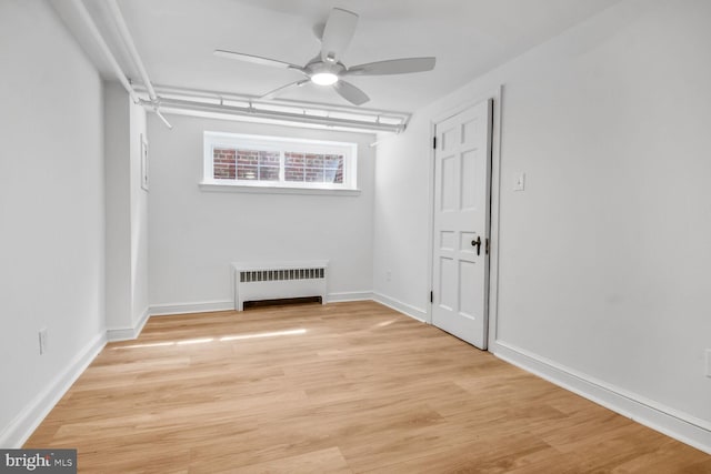 6911 Wells Pkwy, University Park, MD 20782 - unfurnished room with radiator, ceiling fan, light wood-style floors, and baseboards