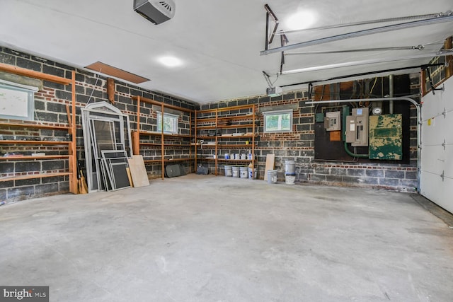 6911 Wells Pkwy, University Park, MD 20782 - garage featuring concrete block wall and a garage door opener