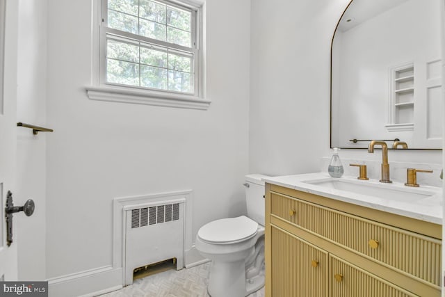 6911 Wells Pkwy, University Park, MD 20782 - bathroom featuring radiator, toilet, and vanity