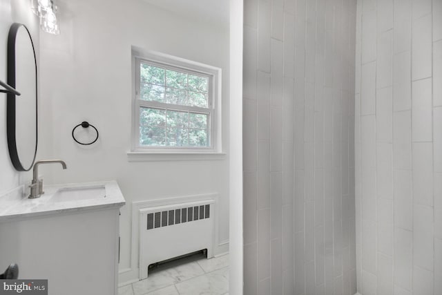 6911 Wells Pkwy, University Park, MD 20782 - full bath with radiator heating unit, marble look tile flooring, and vanity