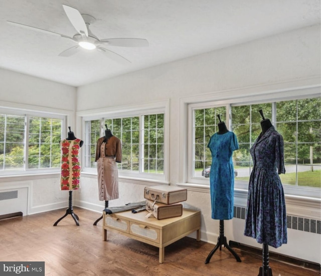 sitting room featuring a ceiling fan, wood finished floors, and radiator