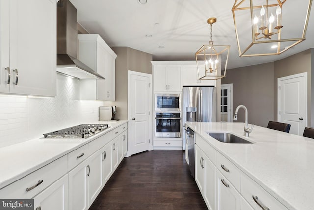 6 Skydance Way, West Chester, PA 19382 - kitchen featuring an inviting chandelier, a sink, white cabinets, wall chimney range hood, and appliances with stainless steel finishes
