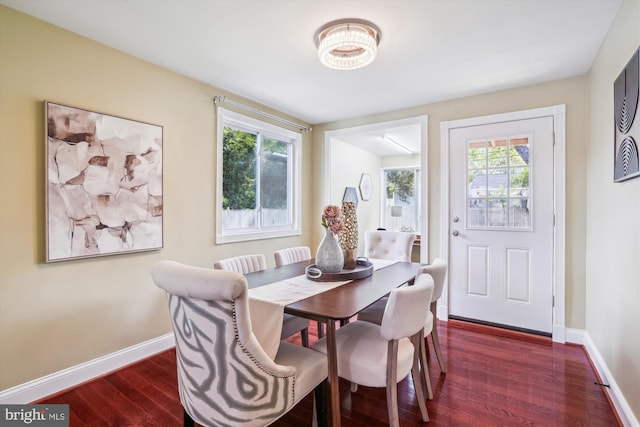 dining area with dark wood-style flooring, baseboards, and plenty of natural light