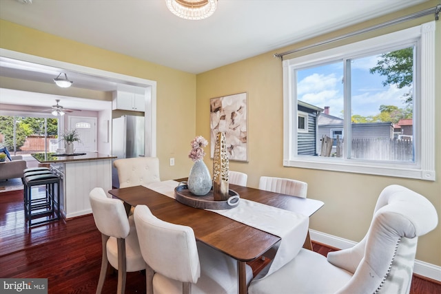 dining area with baseboards and dark wood finished floors
