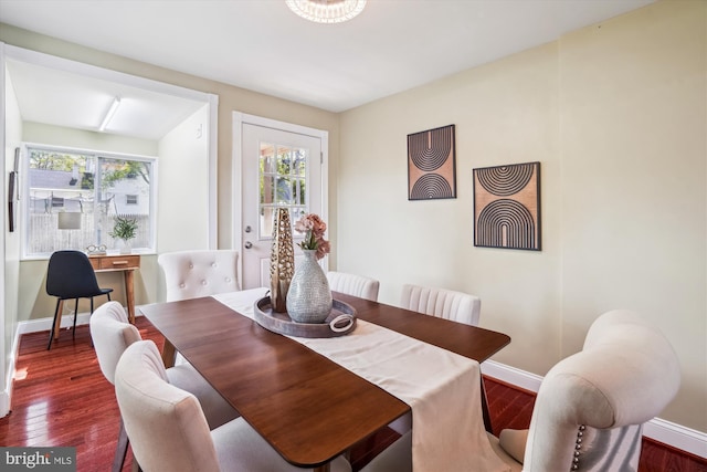 dining space featuring a healthy amount of sunlight, baseboards, and wood finished floors