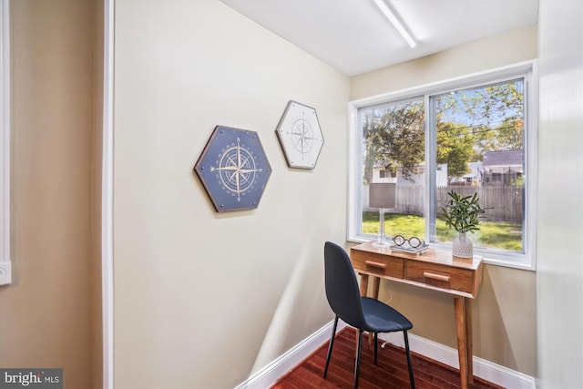 office area with dark wood-style flooring and baseboards