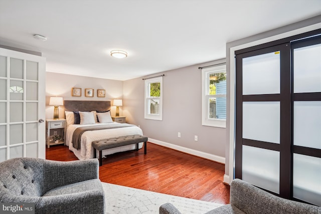 bedroom with baseboards and wood finished floors