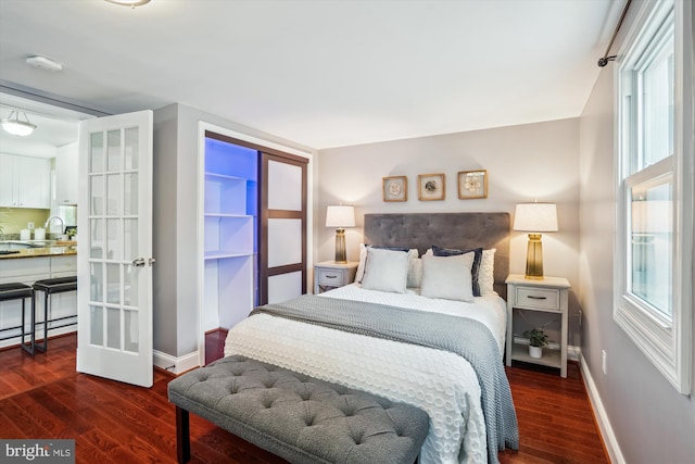 bedroom with baseboards and dark wood-style floors