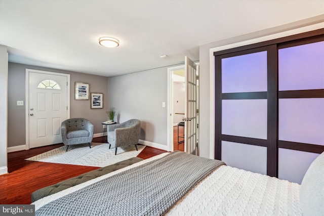 bedroom featuring baseboards and wood finished floors