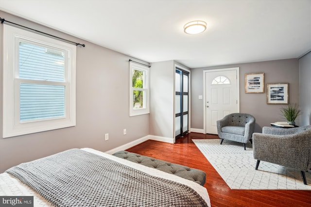 bedroom featuring baseboards and wood finished floors
