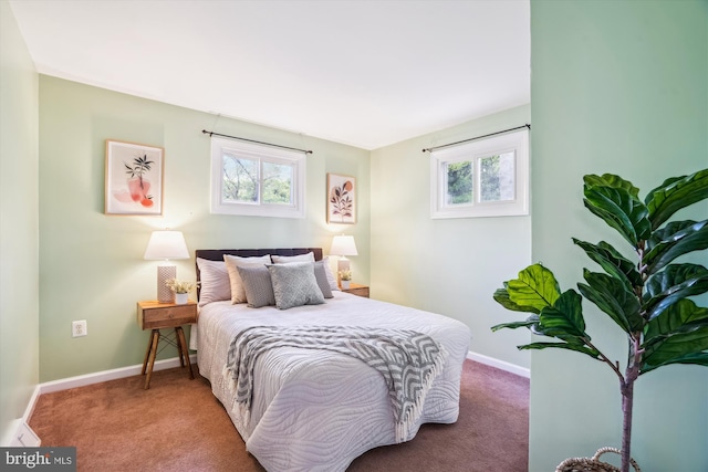 bedroom with baseboards, multiple windows, and carpet flooring