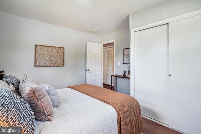 carpeted bedroom featuring a closet