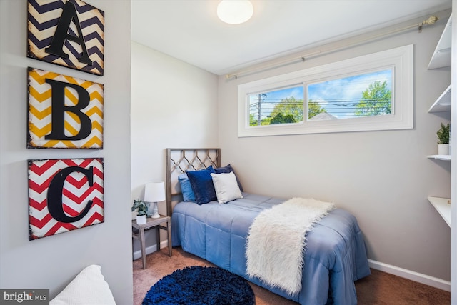 bedroom featuring baseboards and carpet flooring