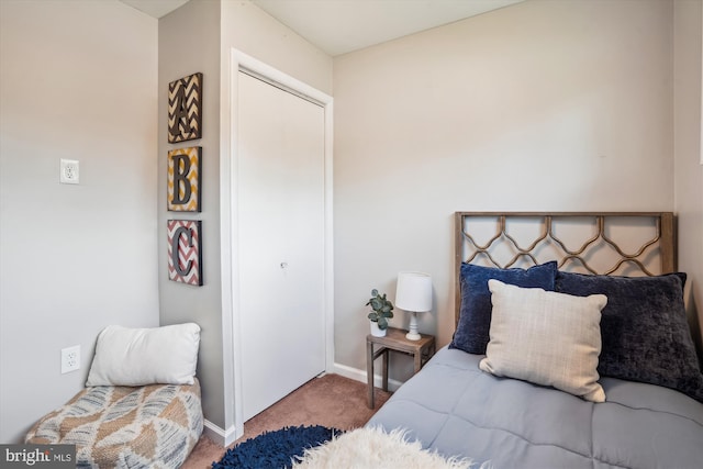 bedroom with carpet floors and baseboards