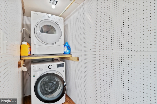washroom with laundry area and stacked washer / drying machine