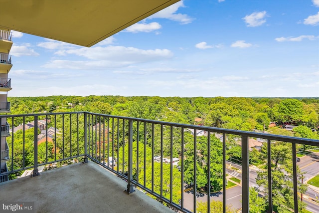 balcony featuring a view of trees