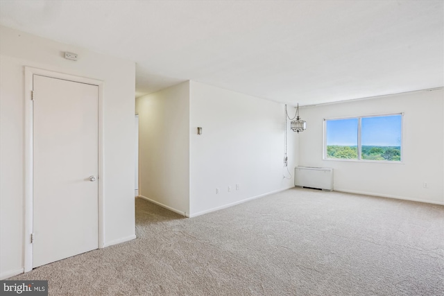 unfurnished room with carpet floors and baseboards