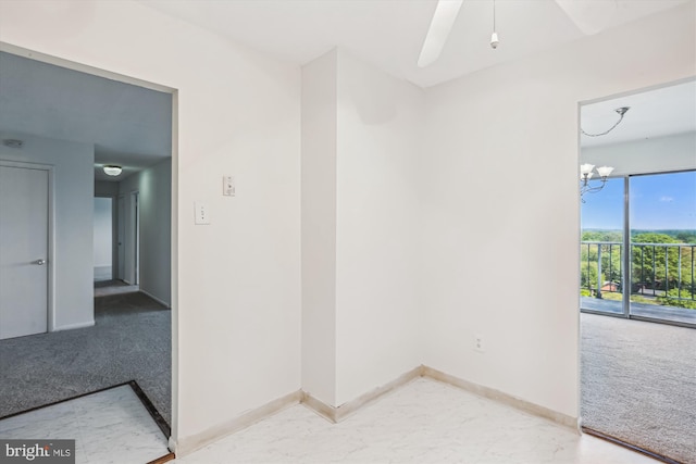 empty room with baseboards and light carpet