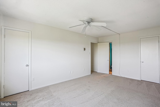 unfurnished bedroom with carpet floors, baseboards, and ceiling fan