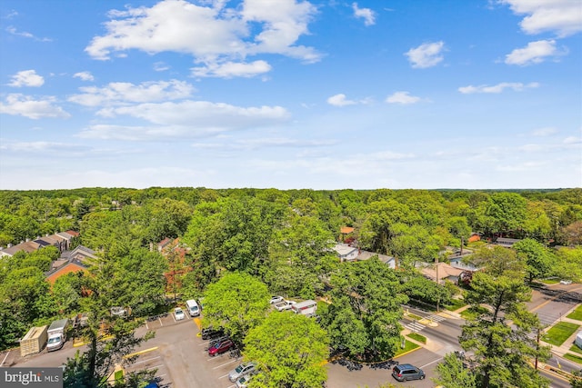 bird's eye view featuring a wooded view