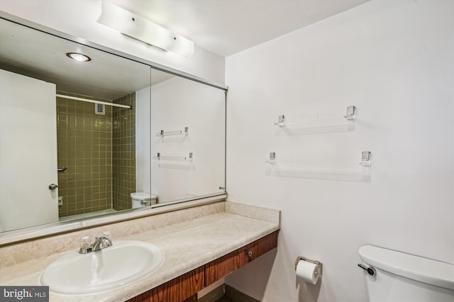 full bath with vanity, walk in shower, and toilet