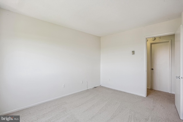 unfurnished room with baseboards and carpet