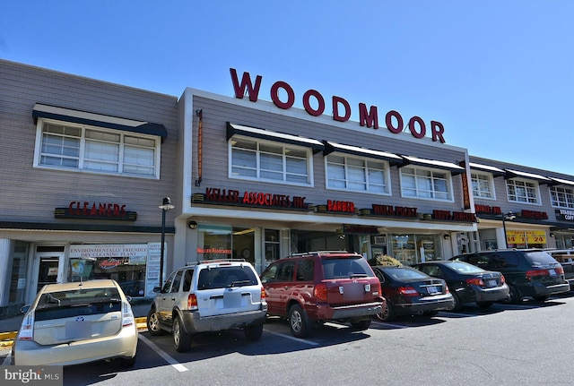view of building exterior featuring uncovered parking