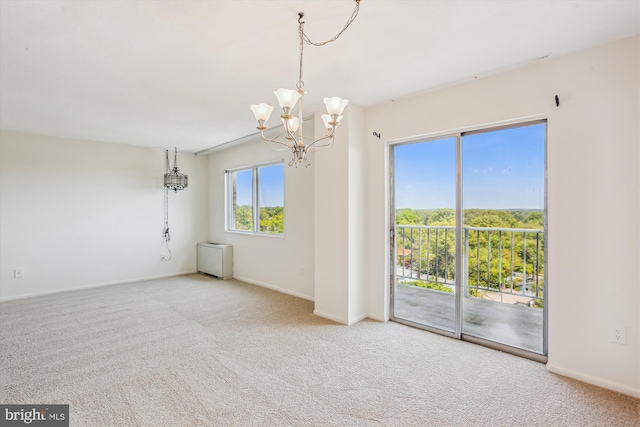 interior space featuring carpet flooring, baseboards, and a notable chandelier