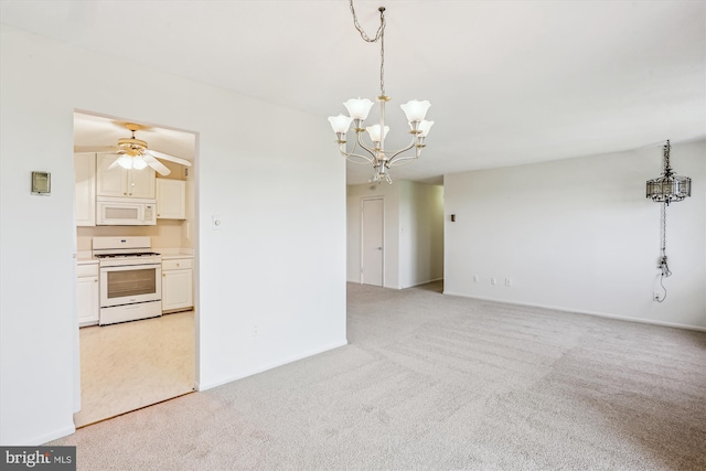 interior space with light colored carpet, baseboards, and ceiling fan with notable chandelier