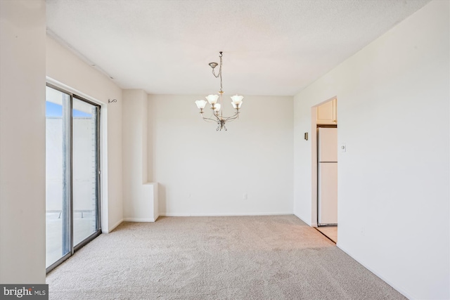 unfurnished room with baseboards, a chandelier, and light carpet