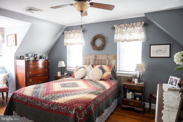 bedroom with visible vents, lofted ceiling, wood finished floors, and ceiling fan