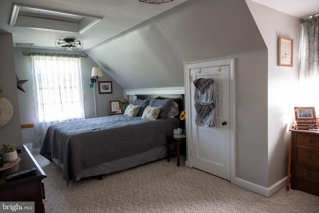carpeted bedroom featuring baseboards and lofted ceiling
