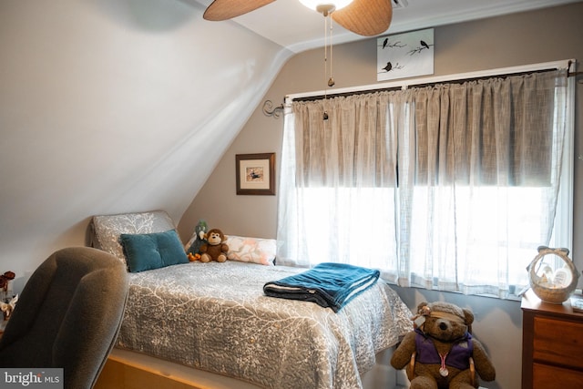 bedroom with a ceiling fan and lofted ceiling